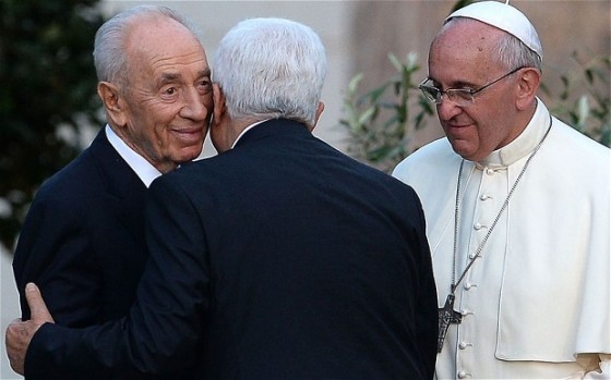 Palestinian & Israeli embrace as the Pope looks on...photo courtesy of the Daily Telegraph.